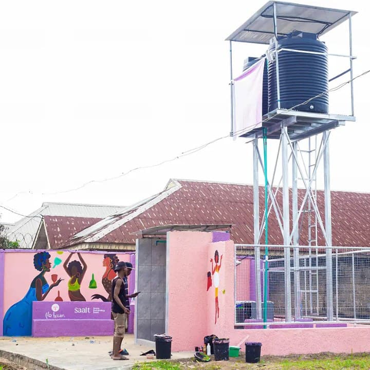 A new water tower and sanitation building with painted murals